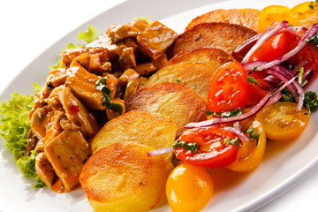 Goulash with baked potatoes and vegetables 