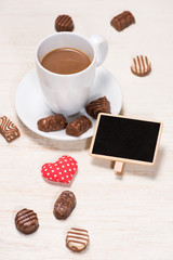 Valentines Day background with chocolate balls, coffee cup, red heart 