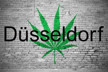Hanfblatt Düsseldorf Cannabis an Ziegelsteinmauer