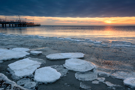 Sunset Over Frozen Baltic Sea In Winter. Poland.