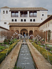 A decorative fountain spraying water inside of Alhambra Fort in Granada, Spain.