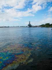 Oil still floats on the top of the water where it was spilled when the USS Arizona was sunk during the attack on Pearl Harbor, Oahu, Hawaii.
