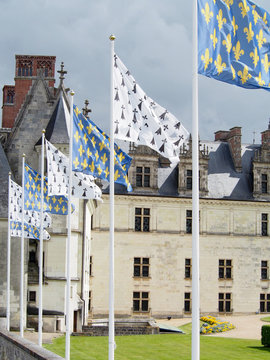 Flags sporting the fleur-de-lis fly in a row in front of the Amboise Chateau in the Loire Valley of France.