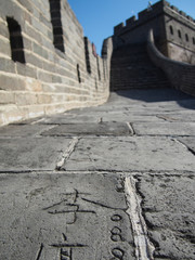 Grafitti carved into the stones that make up the Great Wall of China.