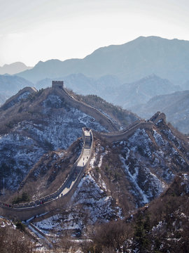 The Great Wall of China sprawls across the Chinese landscape on a cold winter day.