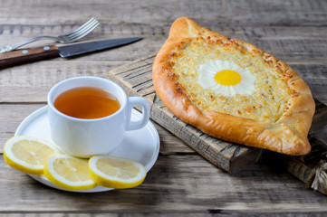 Khachapuri in Adjara with cheese and egg. Traditional Georgian pie.