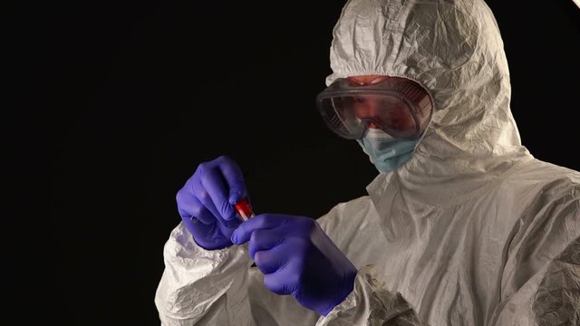 Forensic scientist with evidence tube during crime scene investigation