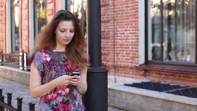 redhead girl walks on the street