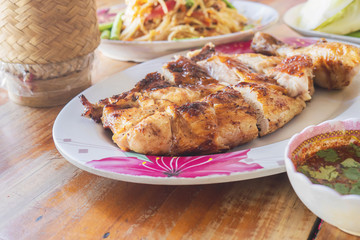 Thai style spicy meal, chicken grilled with spicy papaya salad and sticky rice box