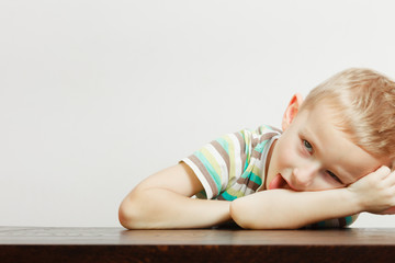 Kid making funny faces being bored