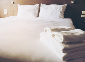 Fototapeta na wymiar White bedding and towel set in modern hotel