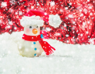 Snow man over blurred red and white background for Christmas new