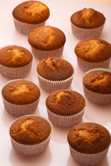 Muffins in paper forms on a mirrored background. Homemade baked