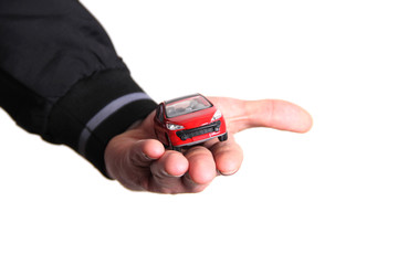 Hand holding a small red car