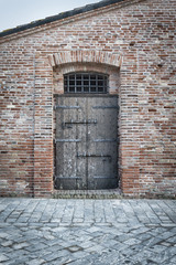 Detail of an old wood door, historic medieval italian city