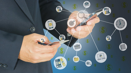 Businessman is using mobile phone and holding card on another ha