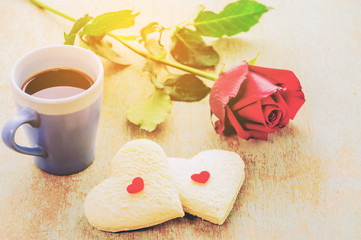 Couple of heart shape white bread with coffee cup and red rose.