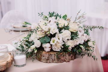 Wedding table decorated with bouquet and candles