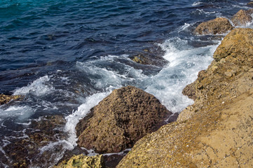 Waves breaking on the rocks of the breakwater.