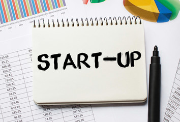 Notebook with Toolls and Notes about Start Up