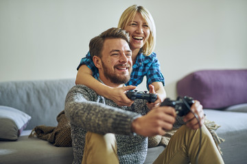 Young cheerful couple at home playing video games © Aleksandar