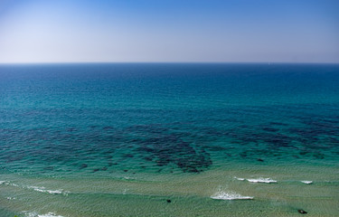 Transparent sea to the horizon, a small wave.