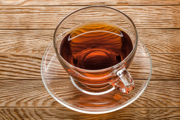 tea in cup of glass on a wooden background
