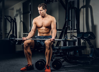 Fototapeta na wymiar A man doing workouts in a gym.