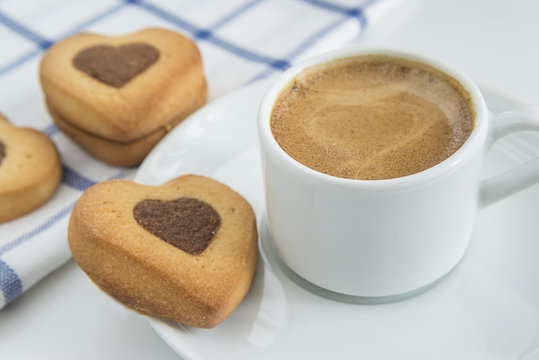 morning coffee concept/cup of coffee and cookies shaped heart on white background 