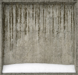 Concrete wall covered with snow.