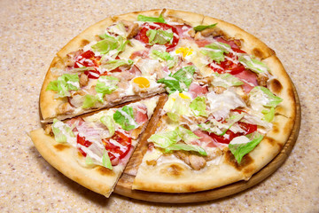 pizza on a round wooden plate.