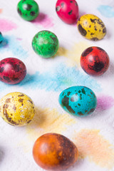 Fototapeta na wymiar Color quail eggs on the paper background