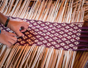 Close up Hands  weaving a woven mat   Thai's artwork.