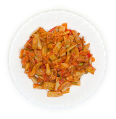 Slices of fried green beans with tomato on a plate top view