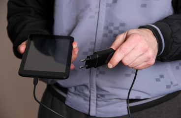 Man charging tablet