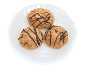 Three cakes on a plate isolated on a white. Top view.