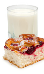 A piece of homemade cake with cherries, cherry jam and a glass o