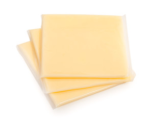 Three yellow cheese slices packaged on white background. Close-u