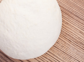 Fresh homemade dough on a beautiful wooden surface. Top view.