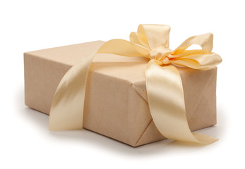 Gift box with present wrapped in kraft paper and gold yellow bow