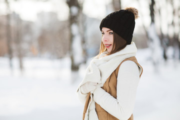 Beautiful young woman wearing merino wool pastel colors hat  morning outdoors. Skin Care, Lip care, care of the eyelashes in the winter season. Beauty young woman Having Fun in Winter Park.