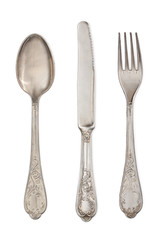 Antique silverware: spoon, knife and fork isolated on a white ba