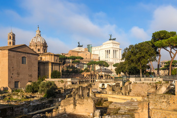 Rome. Italy. Curia Julia, the ruins of Caesar's Forum (54 - 46 BC) and Vittoriano monument