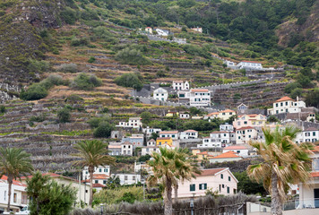Fototapeta premium Fields and houses along west coast near Porto Moniz on Madeira Island. Portugal