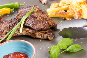 Beef steak with baked potato chips