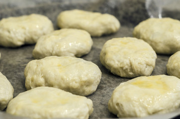 Fototapeta na wymiar the dough on a baking sheet for baking