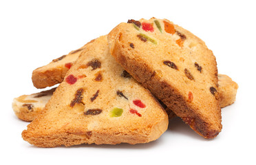 Heap of rusks with candied fruit, isolated on a white background