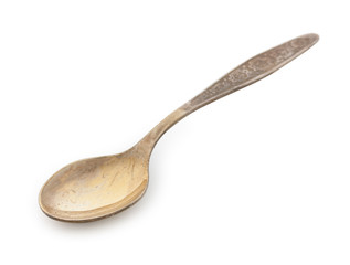 Vintage silverware, old decorated golden teaspoon isolated on a