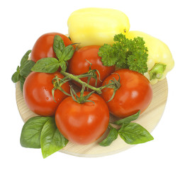 Branch of fresh tomatoes, bell pepper with fresh parsley and bas