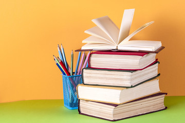 Open book, hardback bookson bright colorful background.